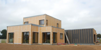 Réalisation d'une MOB, Maison à Ossature Bois, fenêtres et portes fenêtres, baies vitrées Alu de couleur gris anthracite.